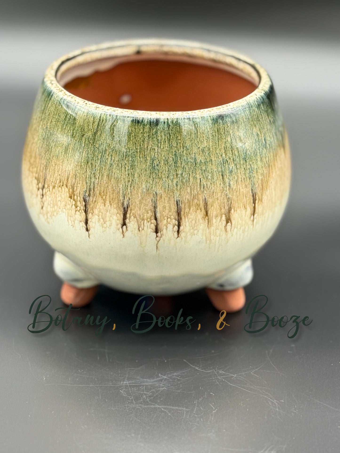 Round dark green from brown to grey glazed